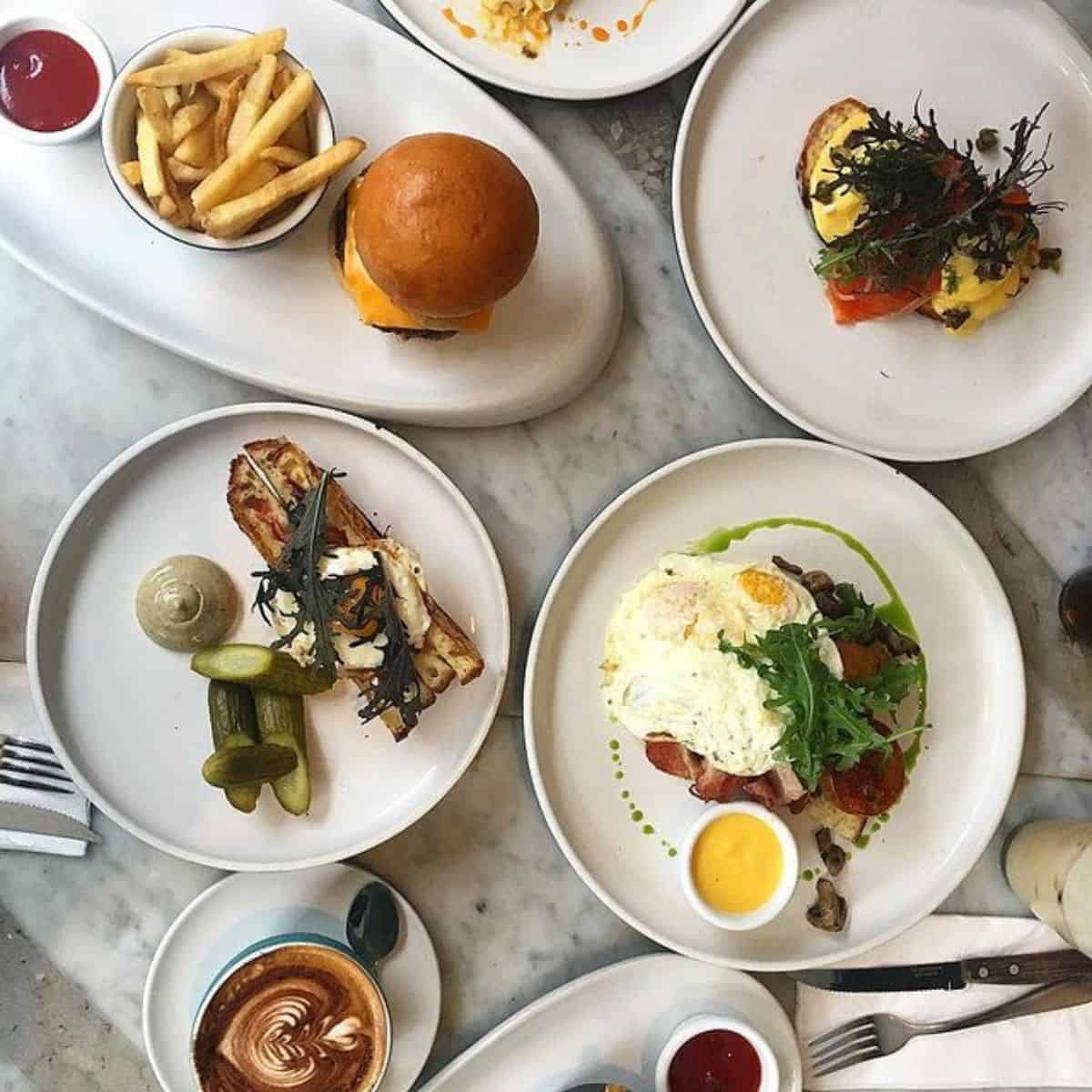 Sisterfields Cafe hamburger, egg, fries, and dips on the side cafes in Bali