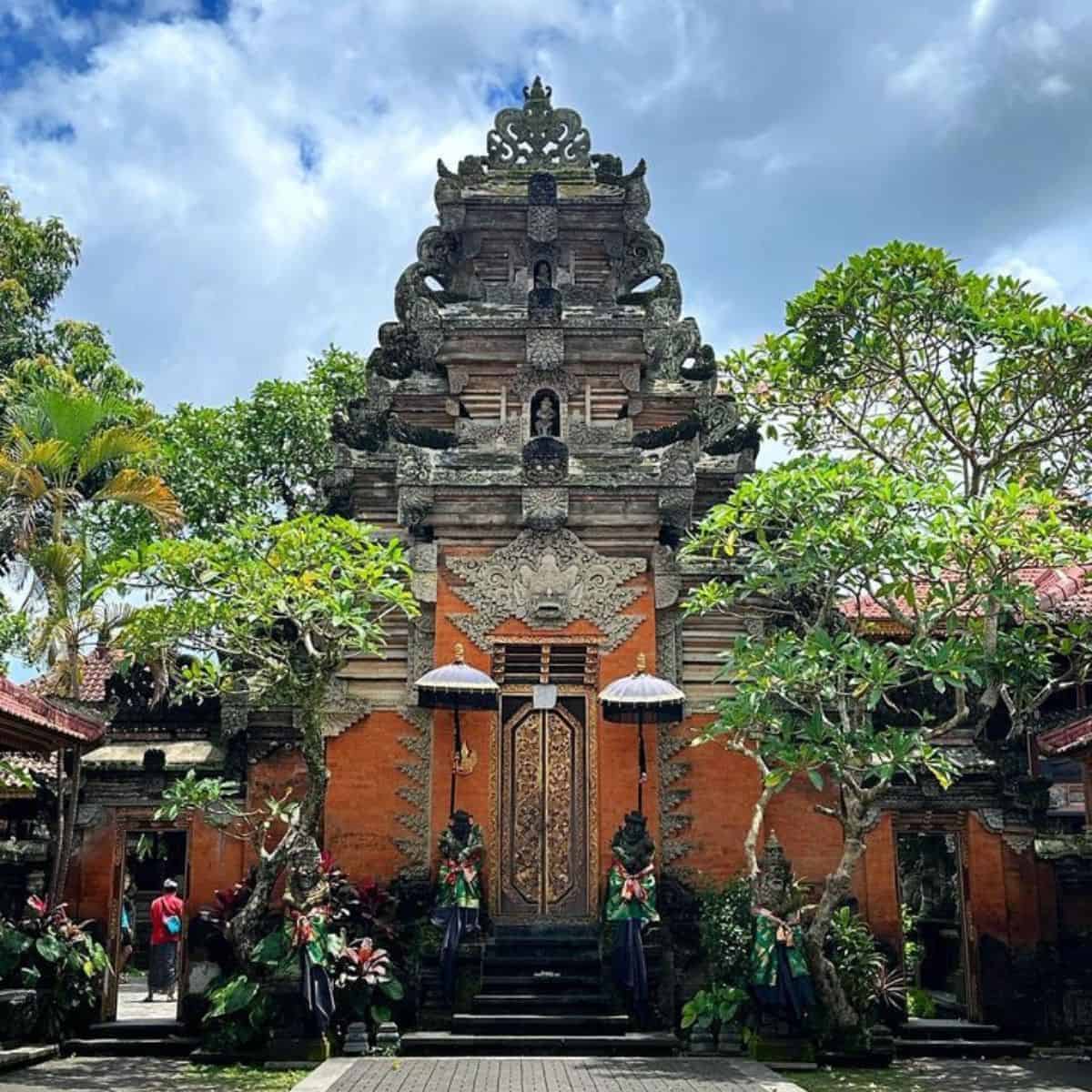 Ubud Palacae orange walls and gold metalwork gate entrance