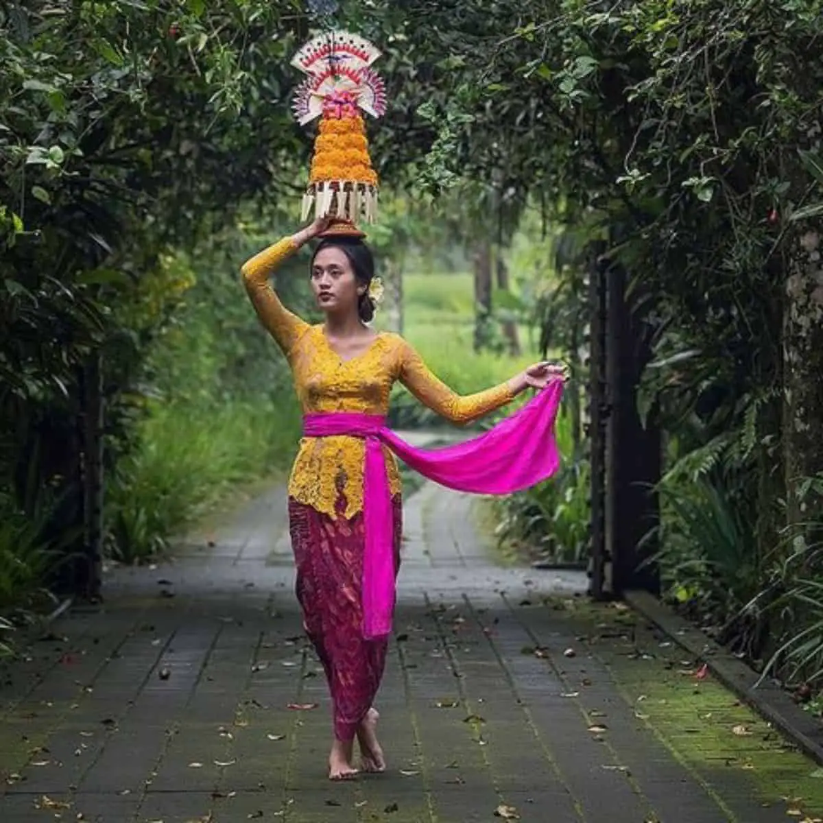Balinese kebaya worn by Balinese woman yellow and purple