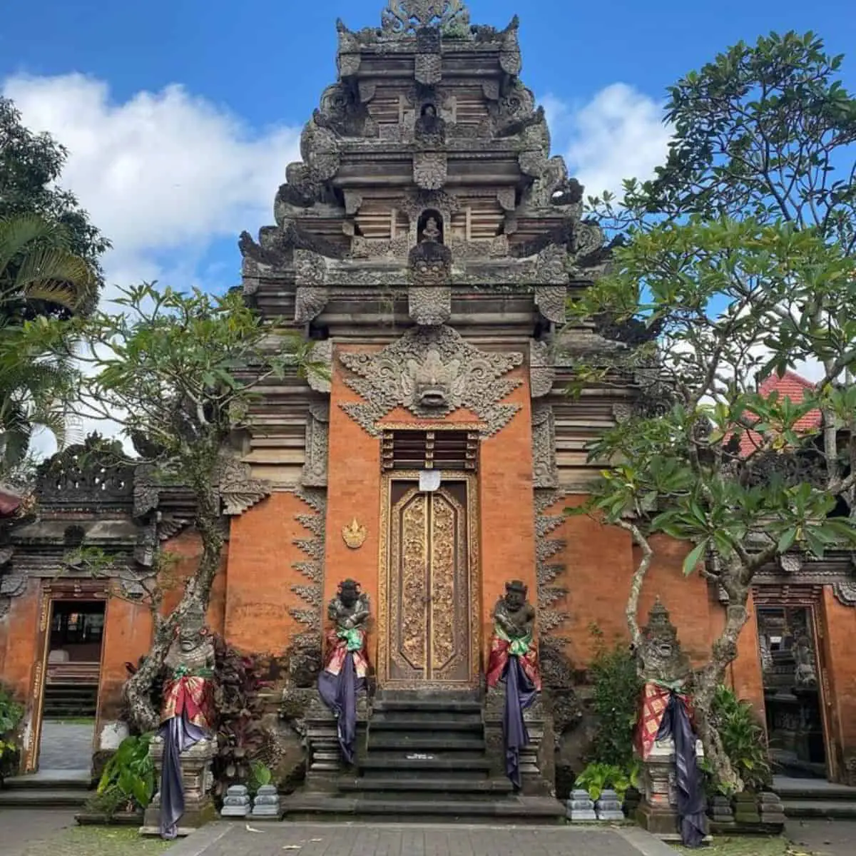 Beautiful exterior of Ubud Palace with four monuments beside the stairs