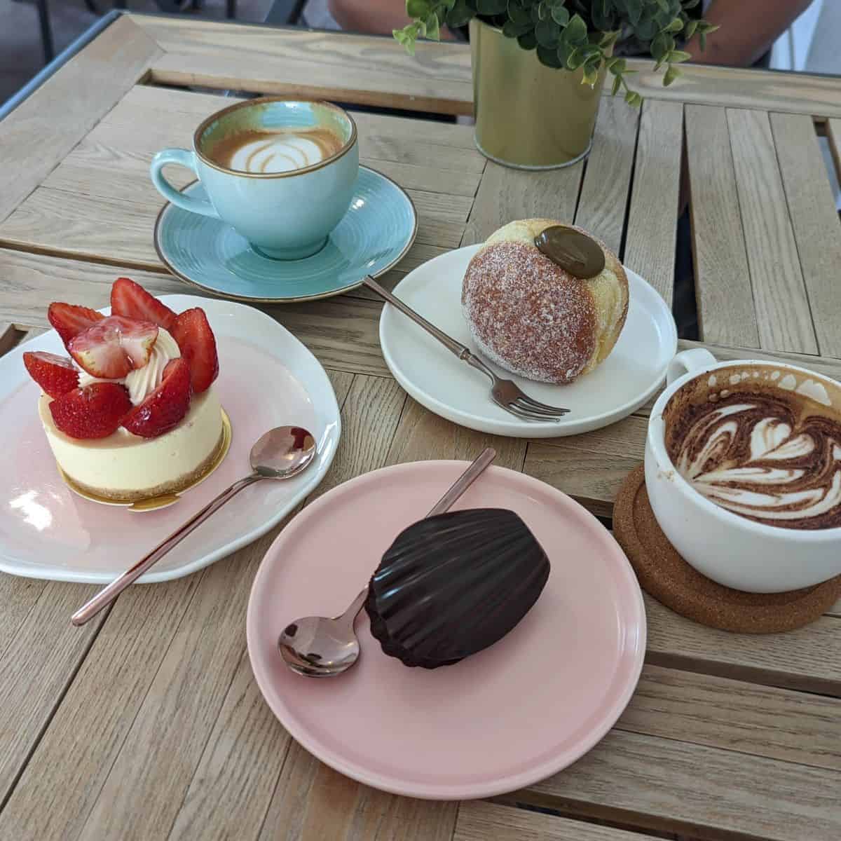 Dark chocolate coated Madeleine, strawberry cheesecake and houjicha beignet at La Vie En Rose