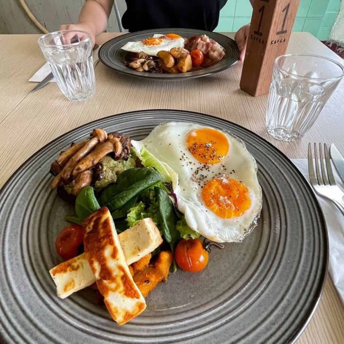 Kafka’s delicious plate of fried eggs, mushrooms and cheese omelette garnished with green leafy veggie