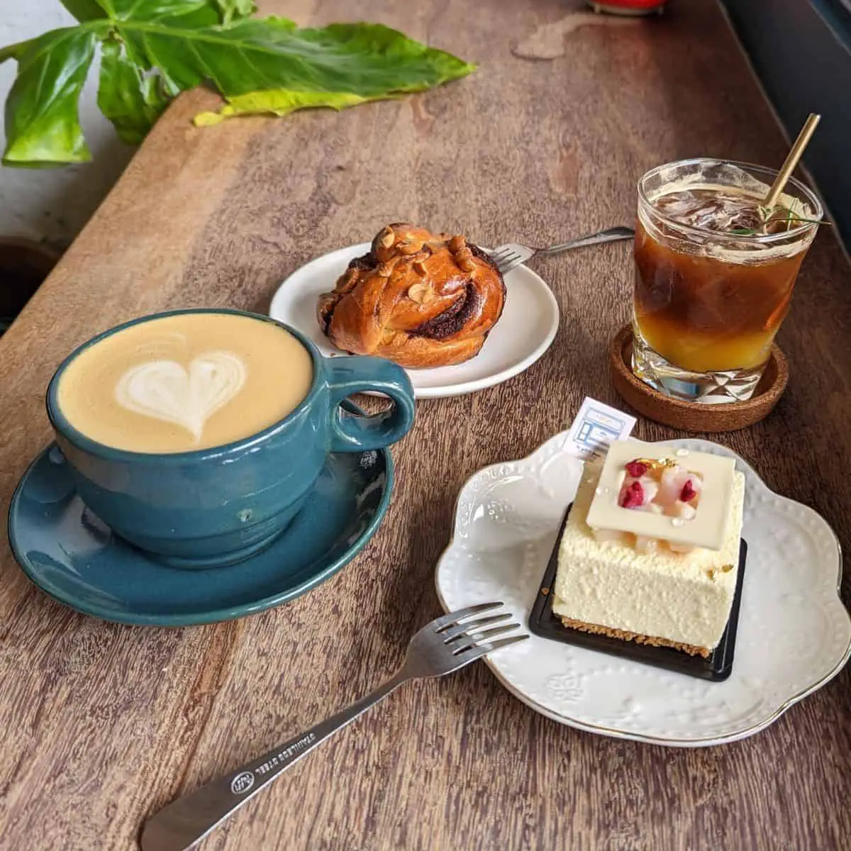 Orange espresso, cafe latte, Enchante cake (lychee syrup and raspberry filling), cinnamon bun at Le petit four patisserie