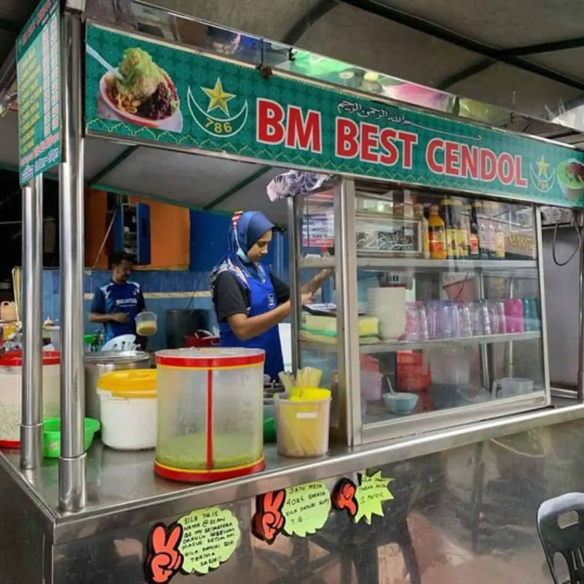 BM Best Cendol stall with two busy staff in blue uniform with green and red signage theme