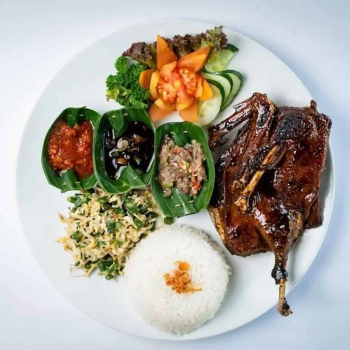  Bebek Tepi Sawah’s traditional grilled duck with Balinese vegetable steam rice and Balinese sambal