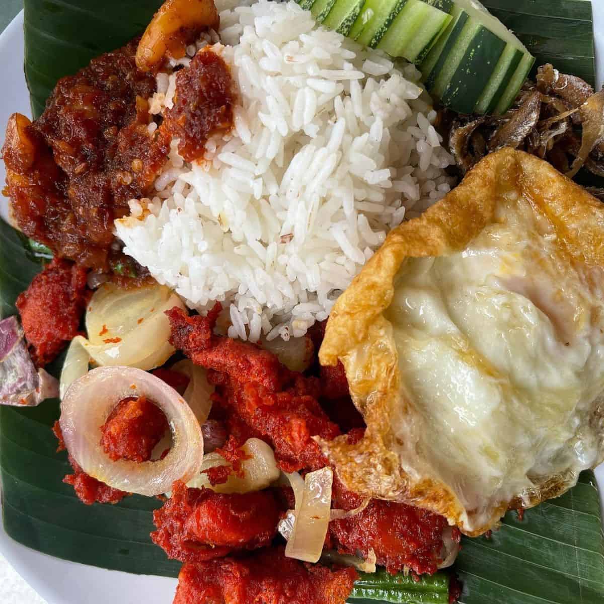 Cik Sue's flavourful plate of Malaysian big breakfast placed in a banana leaf on top of a plate