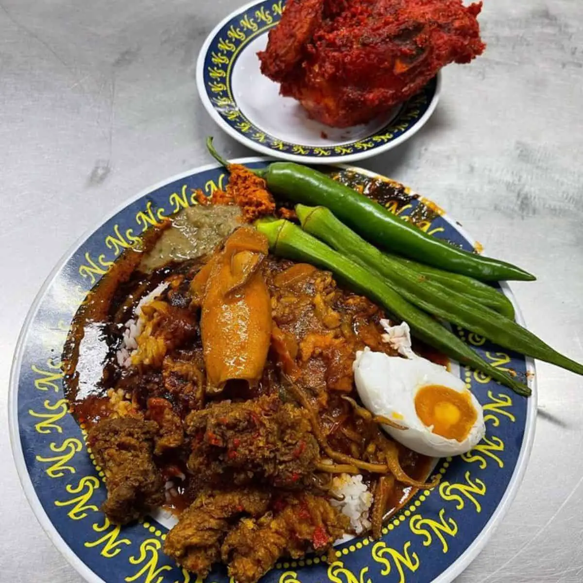 One small plate of fried chicken and medium plate of Nasi Kandar serving with squid at NS Nasi Kandar