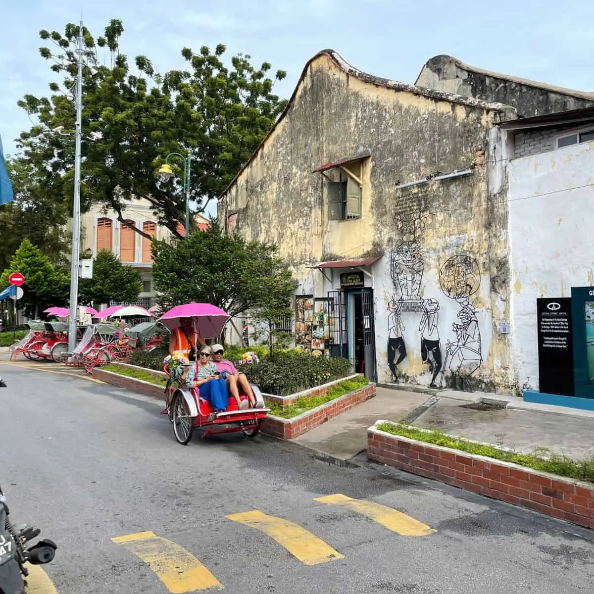 Trishaw ride to while seeing street art in George town Penang