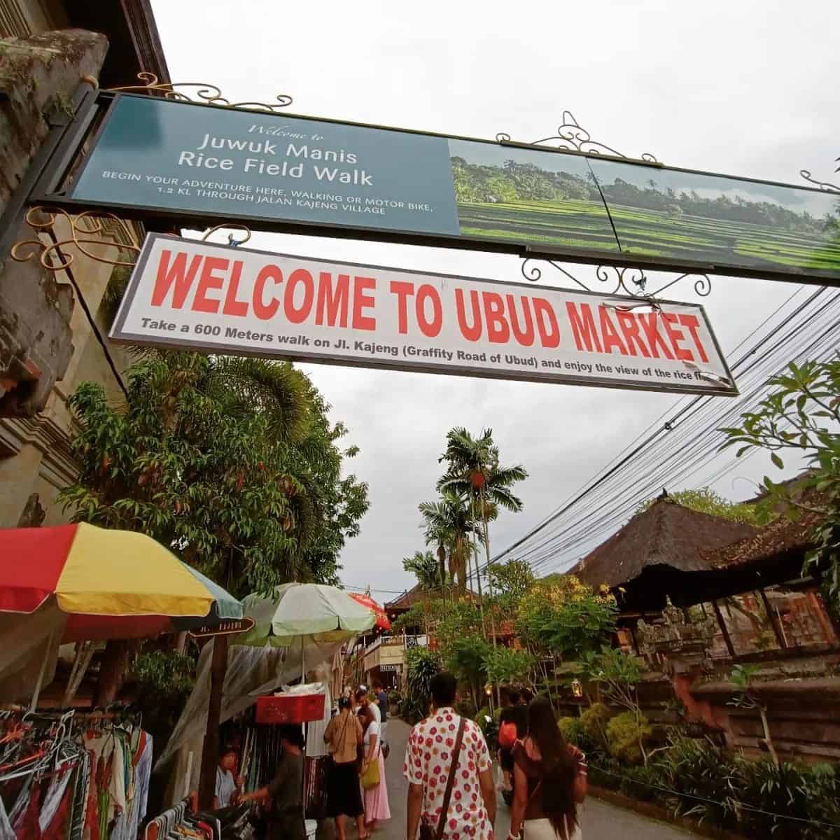 Ubud Market welcome signage with people walking around the area