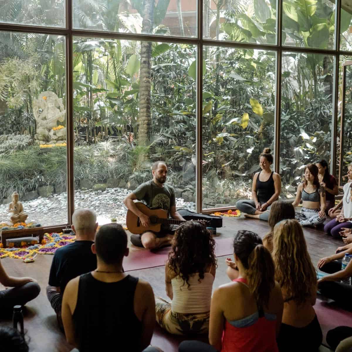 A group of people encircling in Yoga Barn’s room for yoga classes