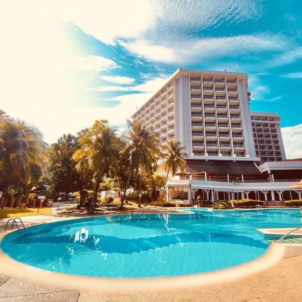 Beautiful clear skies with giant buildings and an outdoor clear pool