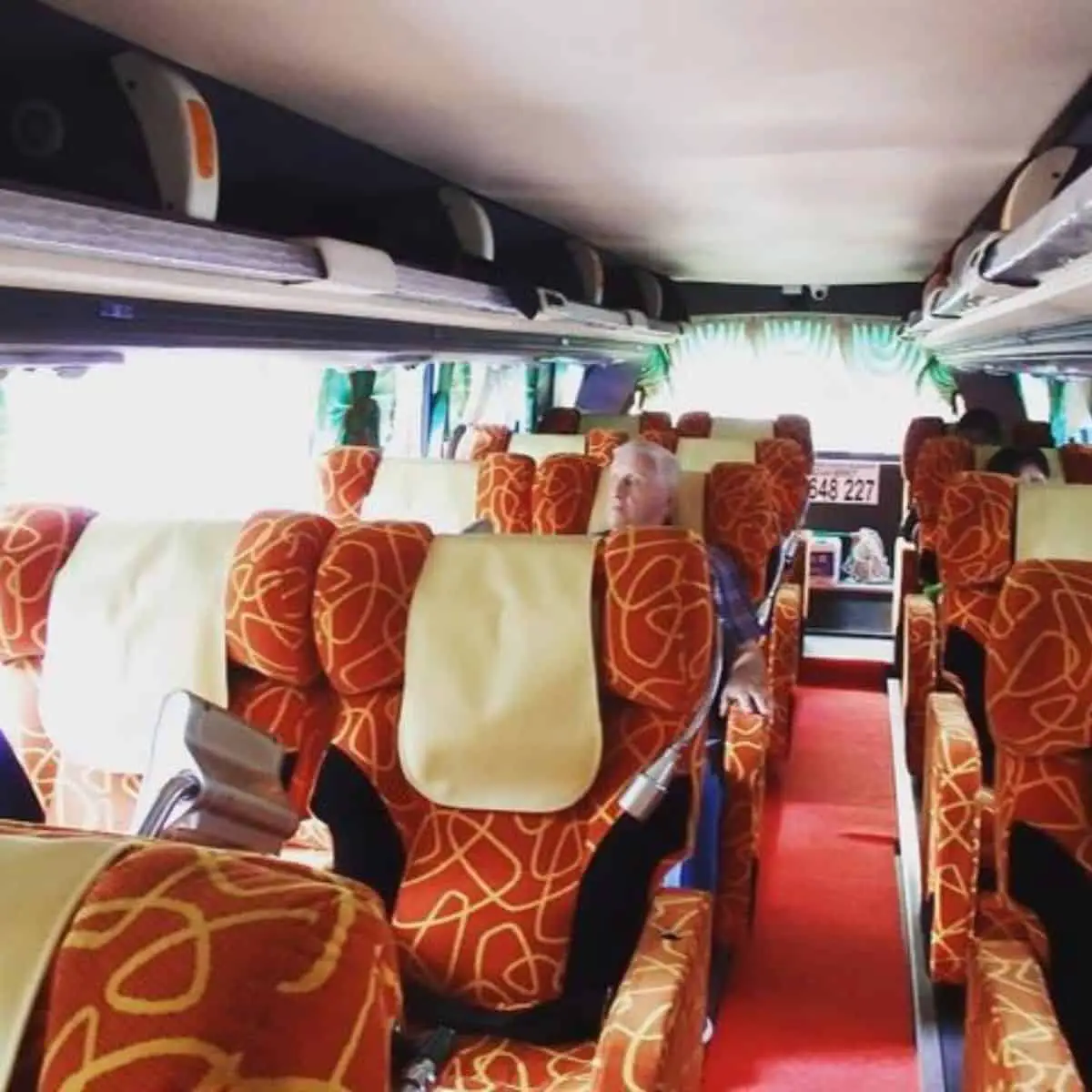 Comfortable seats of a bus transportation with orange hue