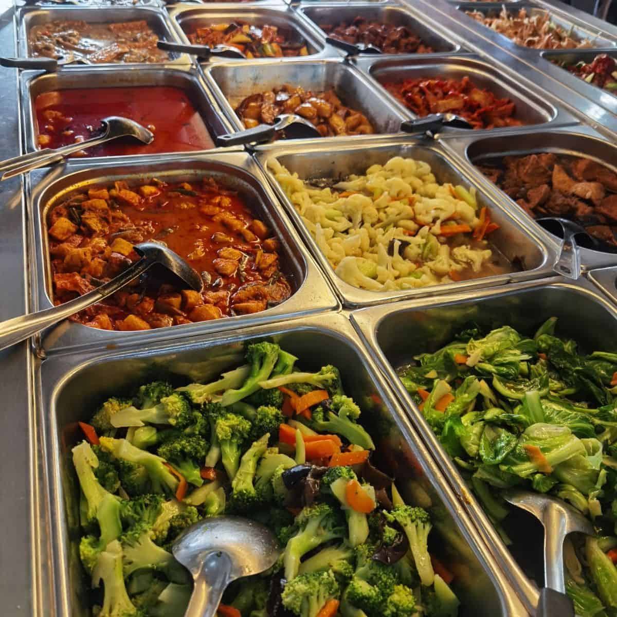 Sumptuous trays of Ee Beng delicacies with orange, yellow, and green hues