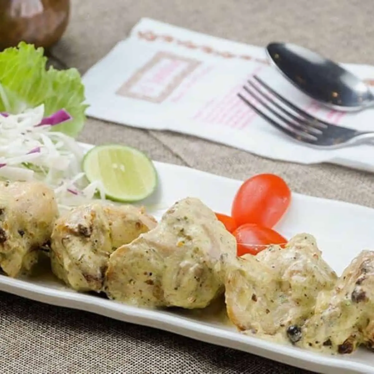 Creamy Indian dish with mixed veggies on a rectangular plate from d Tandoor Restaurant Penang