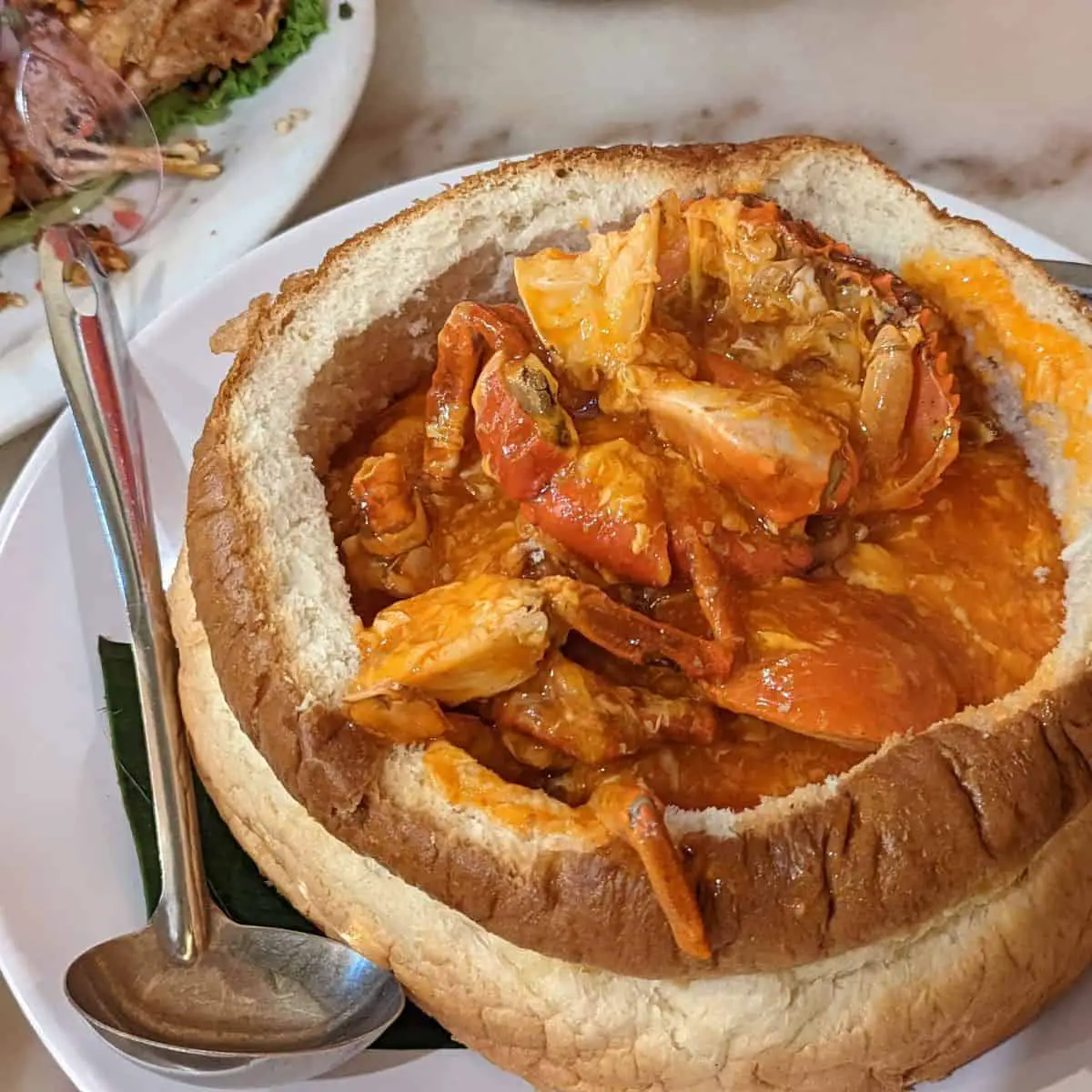Sweet sour chili crab cooked in bread pot