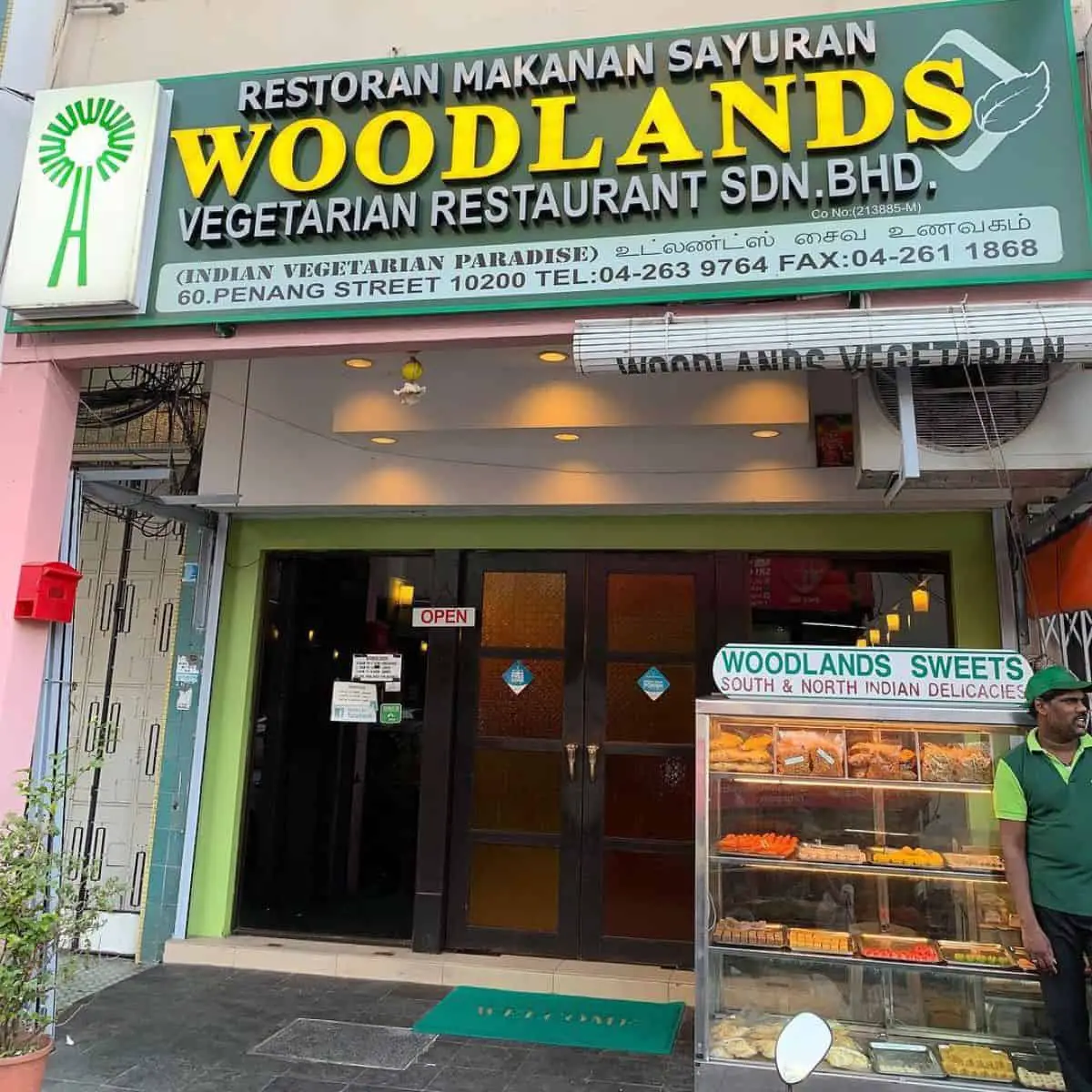 A front view photo of Woodlands Vegetarian Restaurant in Penang with Indian sweets on display