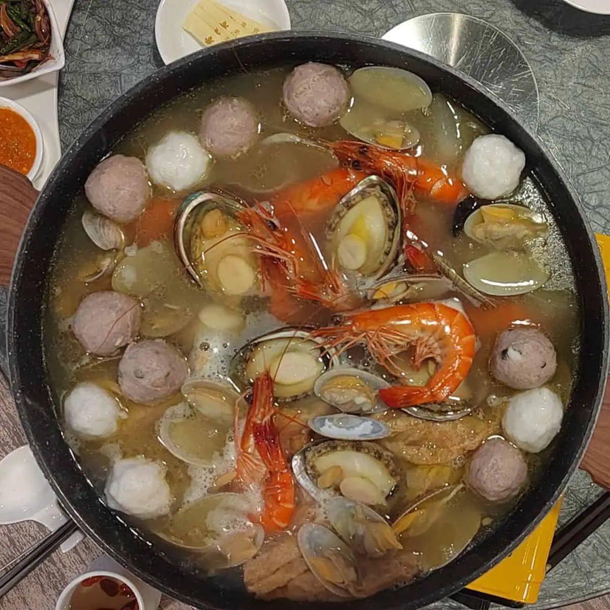 Savoury soup with shrimp, shells and meatballs served by Maple Palace