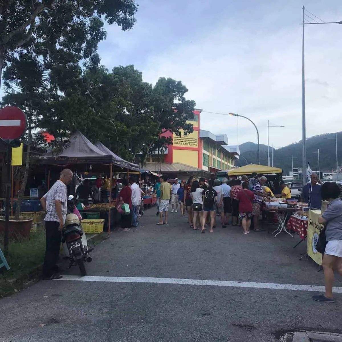 Busy streets of Tanjung Bungah with stalls on every side.