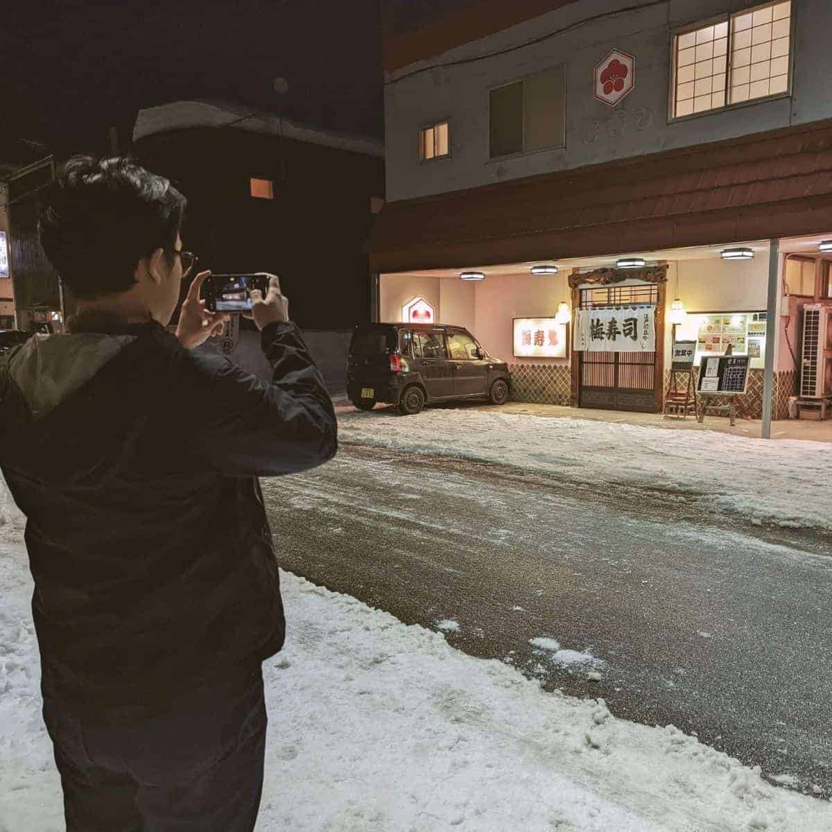 Ruiz taking photo of Ume sushi entrance